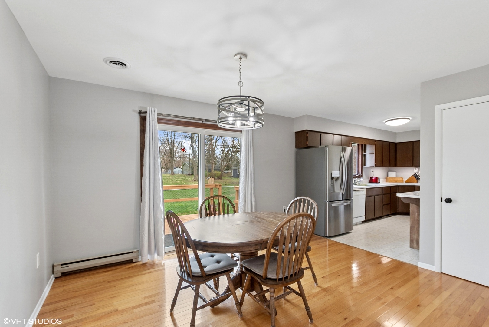 828 South Cedar Road New Lenox, IL 60451 - Photo 6 of 20 a dining room with furniture a chandelier and wooden floor