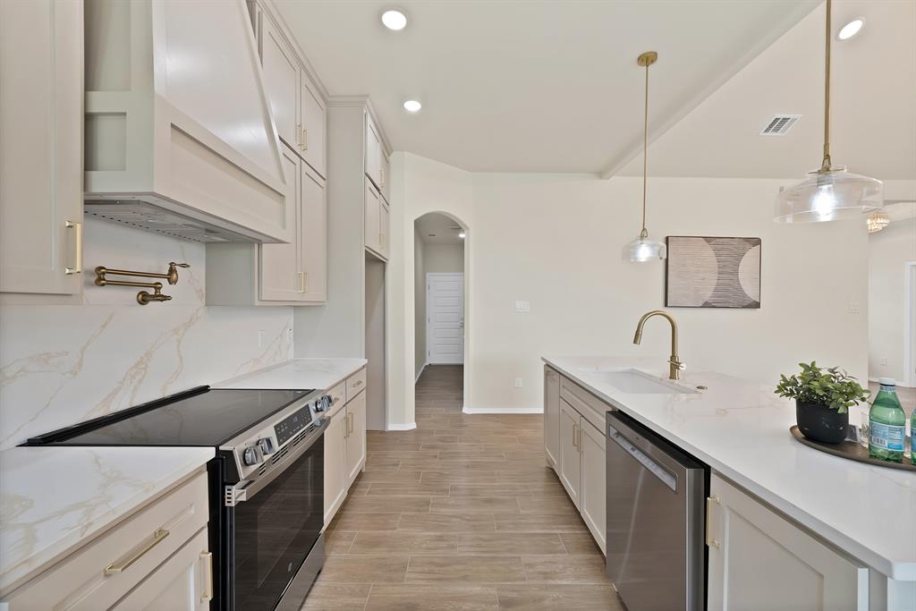 501 Harris Road Azle, TX 76020 - Photo 9 of 29 a kitchen with granite countertop a sink and a stove