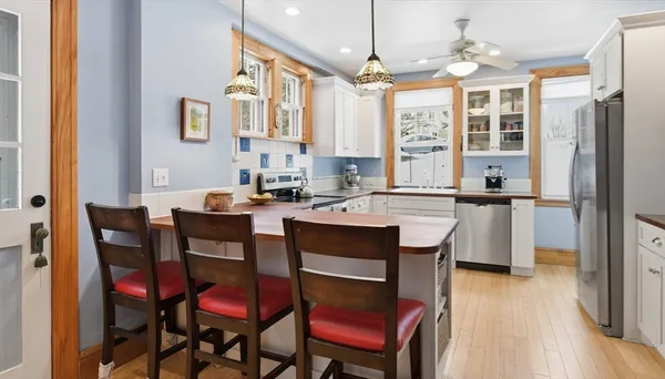 a view of a dining room with furniture and wooden floor