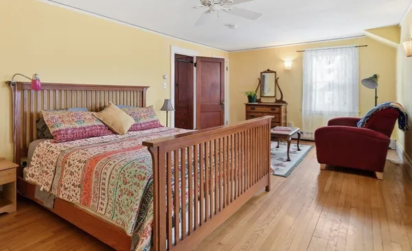 a bedroom with a bed and a couch