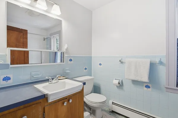 a bathroom with a sink toilet and mirror
