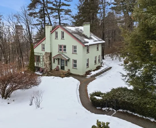 a view of a house with a yard covered in snow