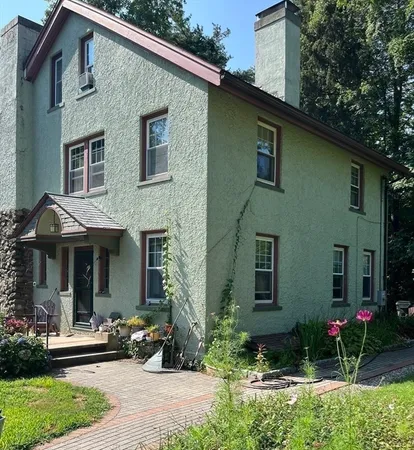 a front view of a house with garden