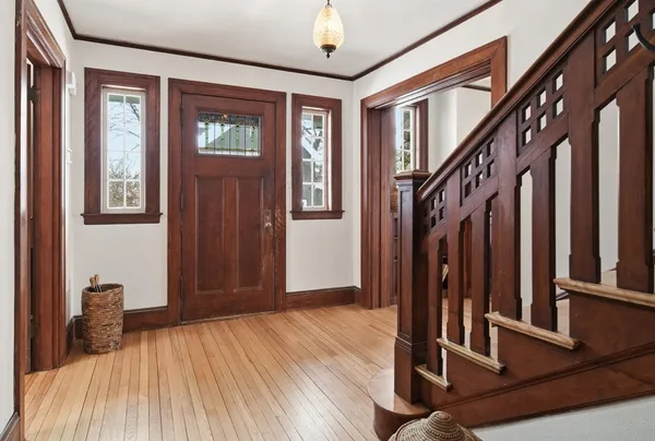 a view of entryway with wooden floor and stairs