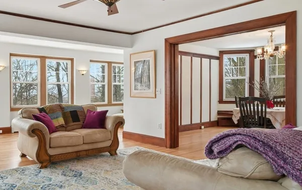 a bedroom with furniture and a large window