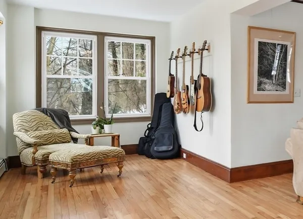 a living room with furniture a window and gym equipment