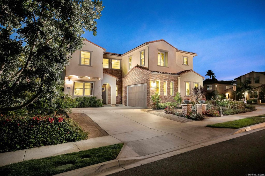 a front view of a house with a garden