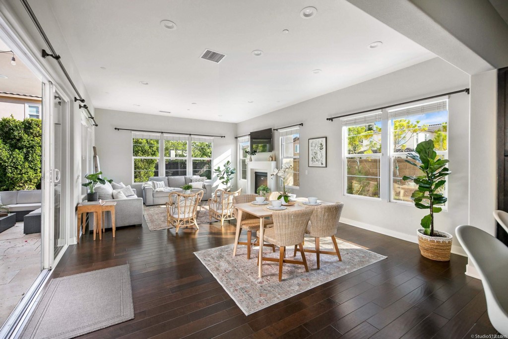 7060 Sitio Caliente Carlsbad, CA 92009 - Photo 13 of 39 a living room with furniture large window and wooden floor