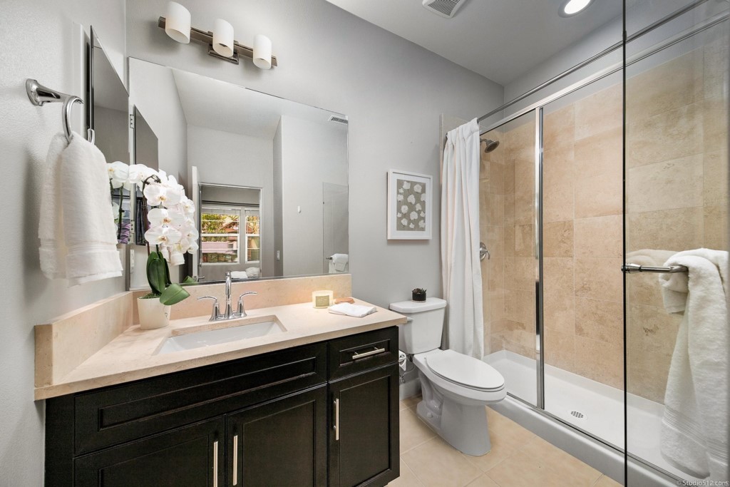 7060 Sitio Caliente Carlsbad, CA 92009 - Photo 16 of 39 a bathroom with a sink a toilet and shower