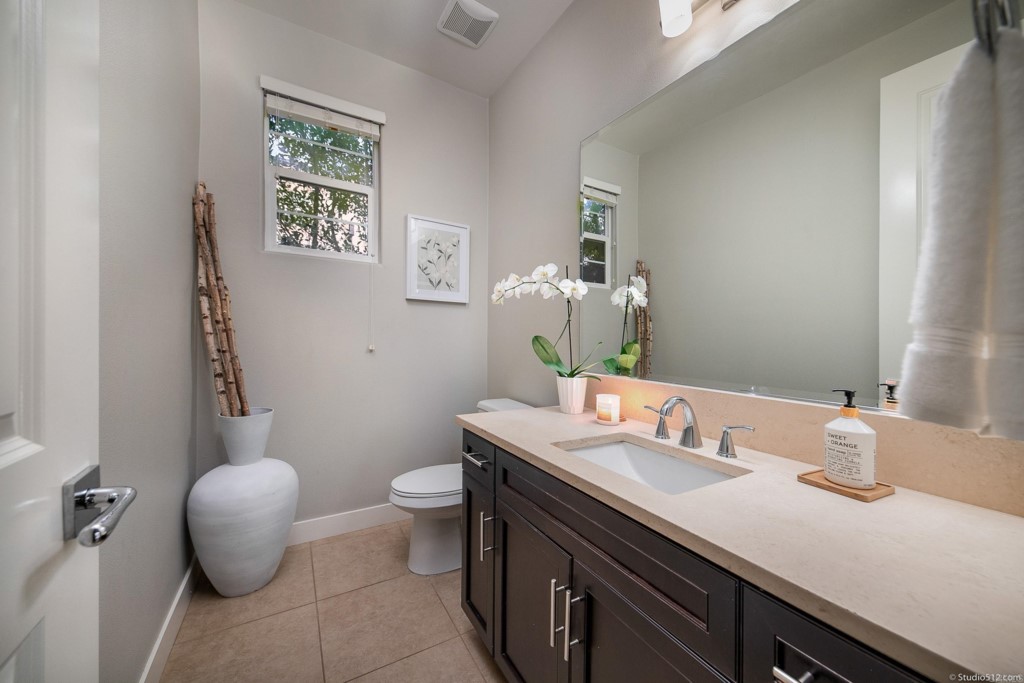 7060 Sitio Caliente Carlsbad, CA 92009 - Photo 17 of 39 a bathroom with a granite countertop sink and a mirror