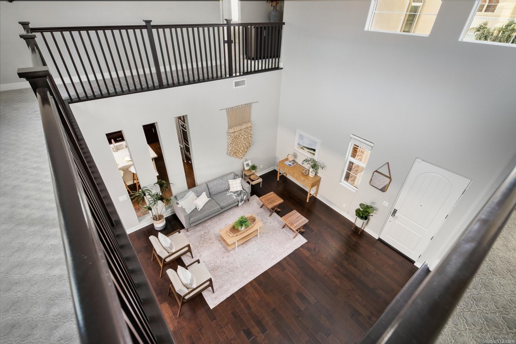 7060 Sitio Caliente Carlsbad, CA 92009 - Photo 18 of 39 a view of a living room with furniture and wooden floor
