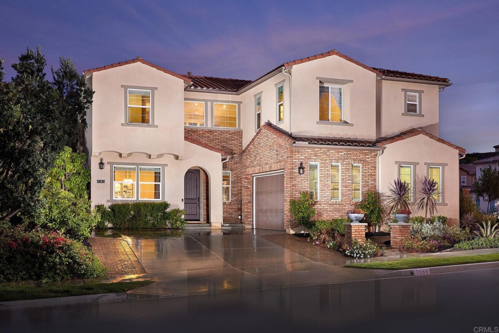 7060 Sitio Caliente Carlsbad, CA 92009 - Photo 2 of 39 a front view of a house with garden