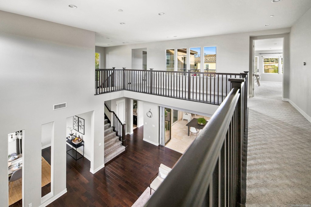 7060 Sitio Caliente Carlsbad, CA 92009 - Photo 26 of 39 a view of entryway with wooden floor and stairs