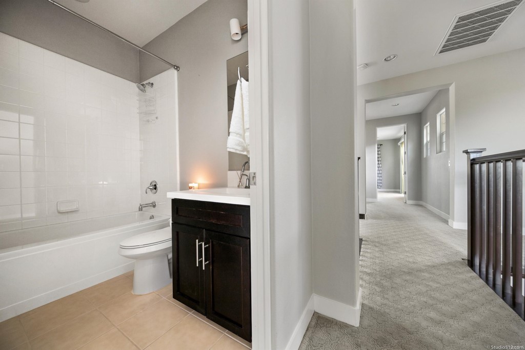 7060 Sitio Caliente Carlsbad, CA 92009 - Photo 28 of 39 a bathroom with a toilet sink and a bathtub