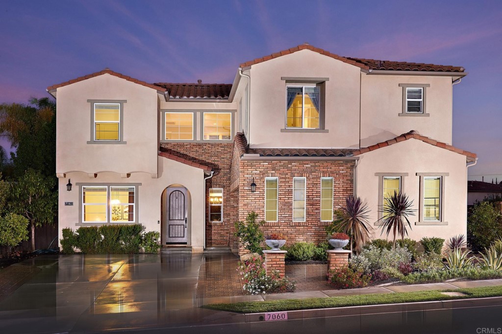7060 Sitio Caliente Carlsbad, CA 92009 - Photo 3 of 39 a front view of a house with garden