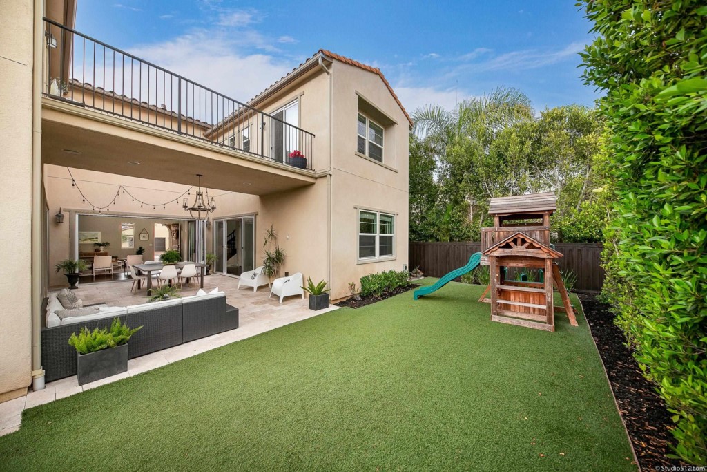 7060 Sitio Caliente Carlsbad, CA 92009 - Photo 31 of 39 a view of a house with a yard and furniture