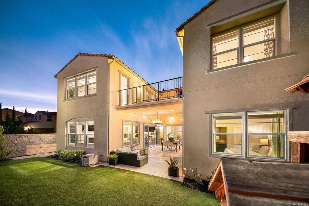 7060 Sitio Caliente Carlsbad, CA 92009 - Photo 33 of 39 a front view of a house with a yard