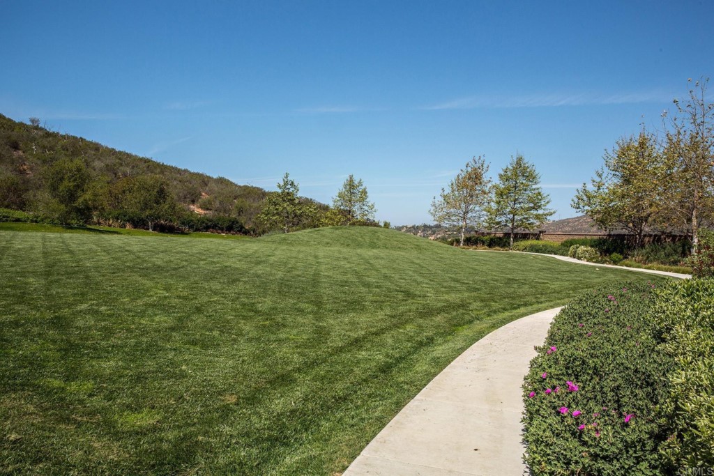 7060 Sitio Caliente Carlsbad, CA 92009 - Photo 36 of 39 a view of a lake with a house in the background