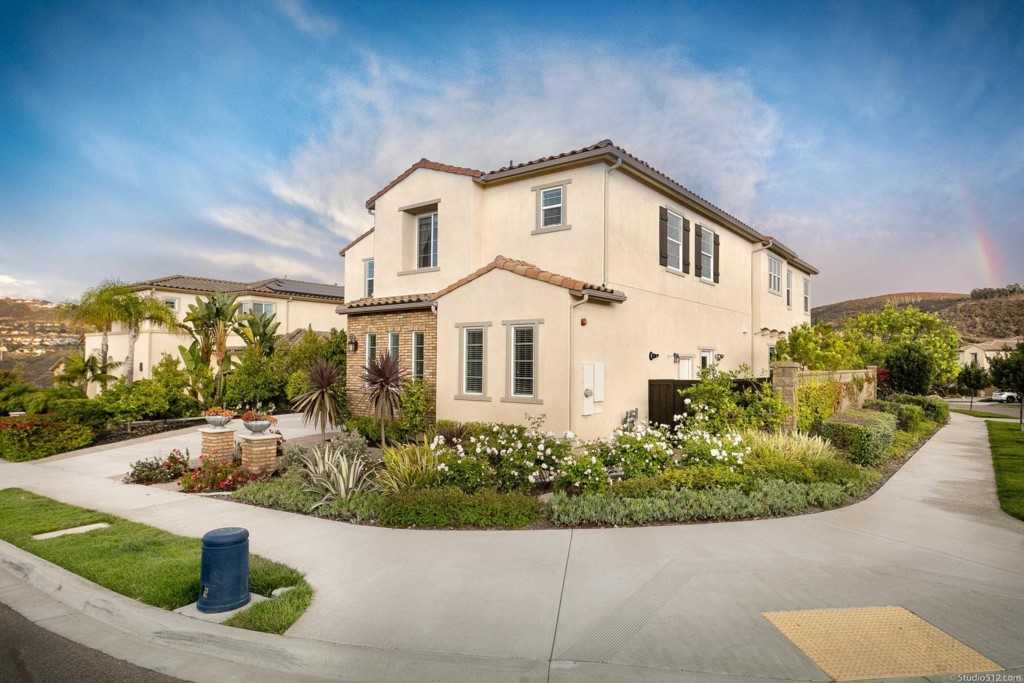 7060 Sitio Caliente Carlsbad, CA 92009 - Photo 4 of 39 a front view of a house with a yard
