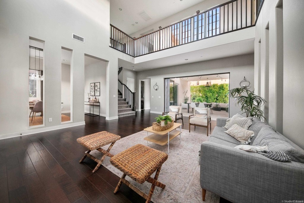 7060 Sitio Caliente Carlsbad, CA 92009 - Photo 9 of 39 a living room with furniture and a wooden floor