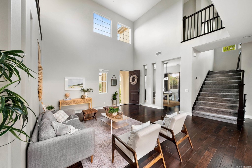 7060 Sitio Caliente Carlsbad, CA 92009 - Photo 10 of 39 a living room with furniture a fireplace and wooden floor