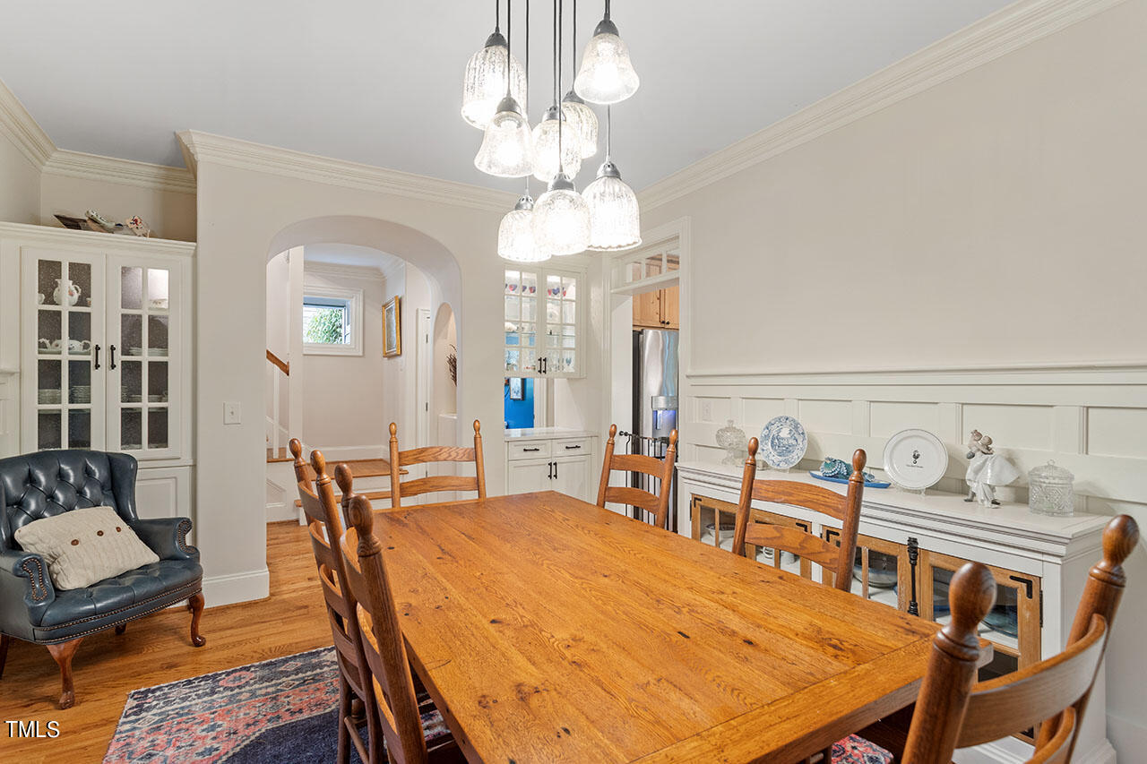 808 Elm Street Raleigh, NC 27604 - Photo 11 of 44 a dining room with furniture a chandelier and wooden floor