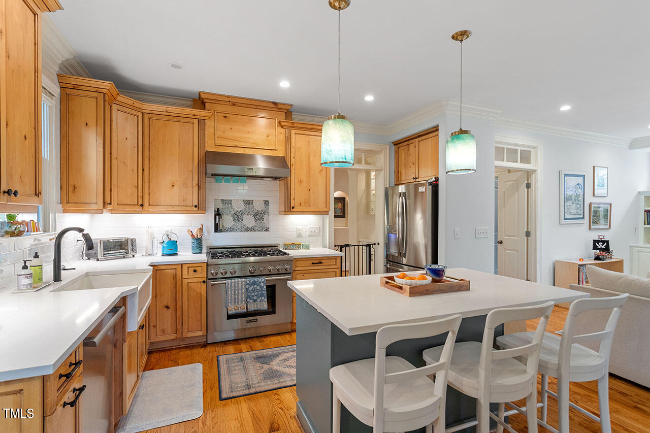 808 Elm Street Raleigh, NC 27604 - Photo 17 of 44 a kitchen with a table chairs stove and refrigerator