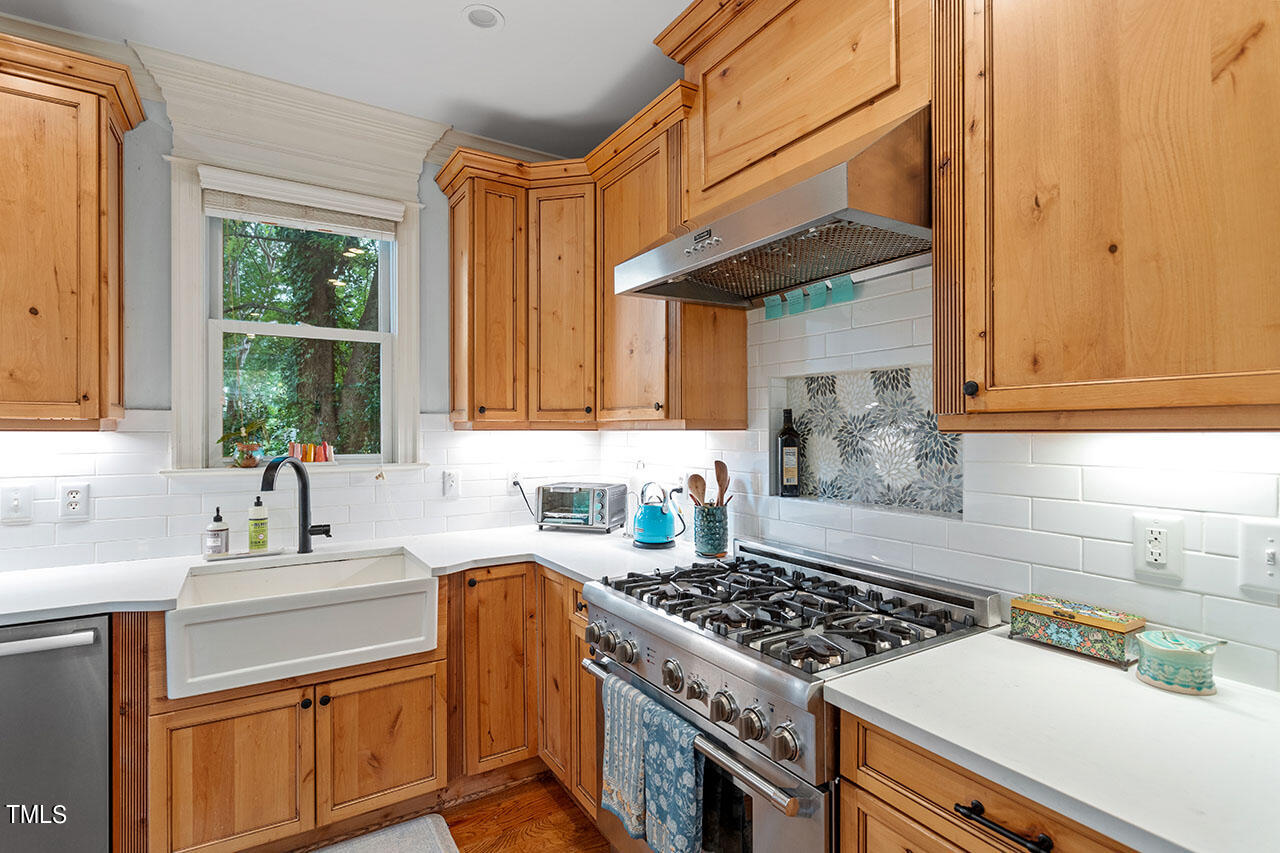 808 Elm Street Raleigh, NC 27604 - Photo 18 of 44 a kitchen with a stove a sink and a refrigerator