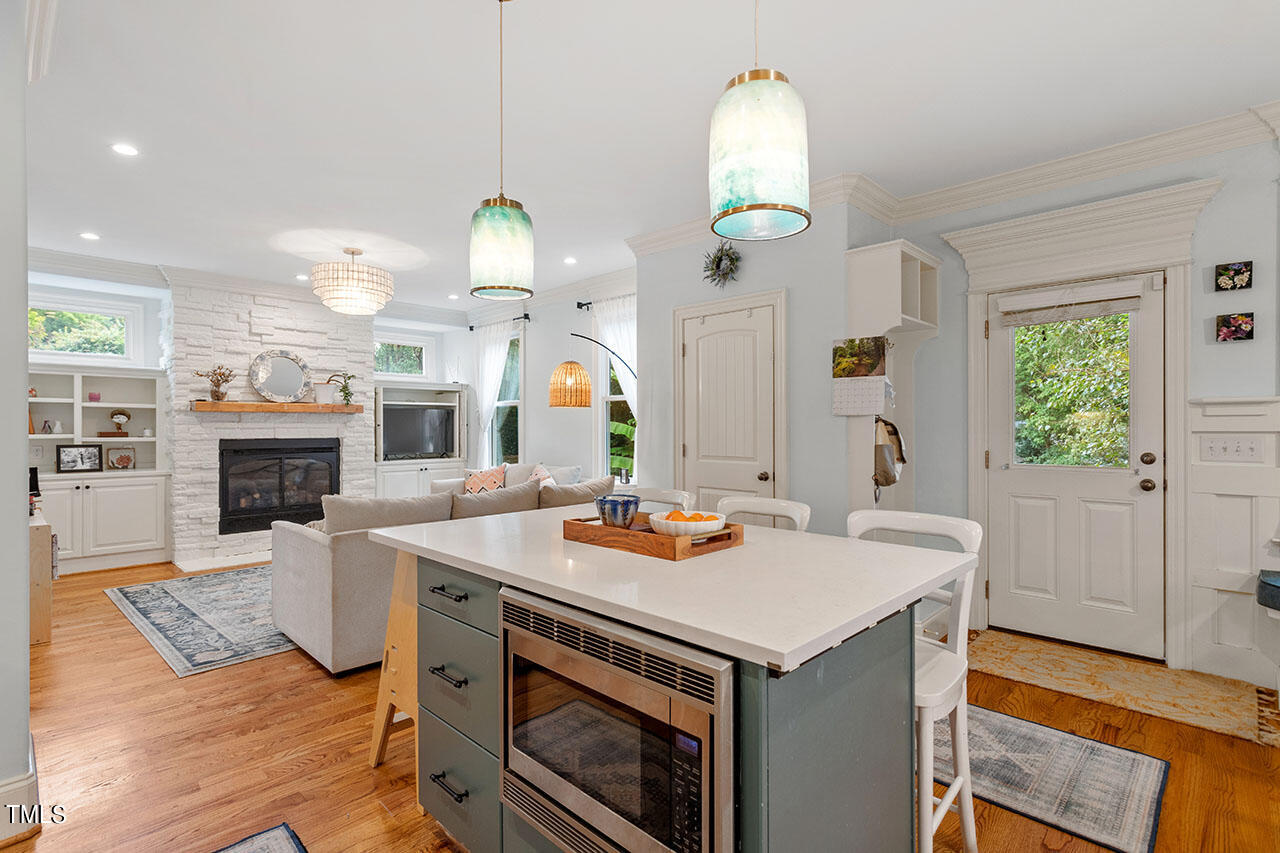 808 Elm Street Raleigh, NC 27604 - Photo 19 of 44 a kitchen with a stove cabinets and living room view