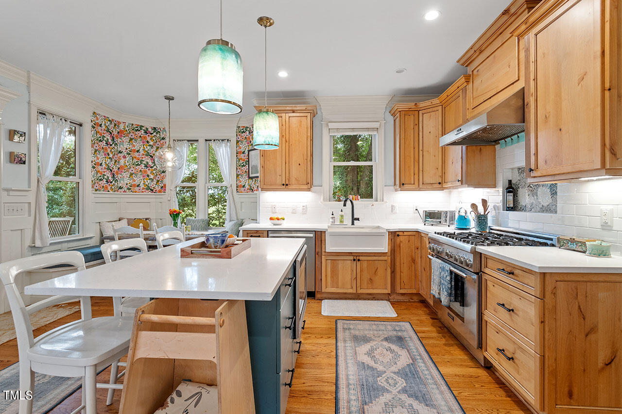 808 Elm Street Raleigh, NC 27604 - Photo 20 of 44 a large kitchen with kitchen island granite countertop a sink and a stove