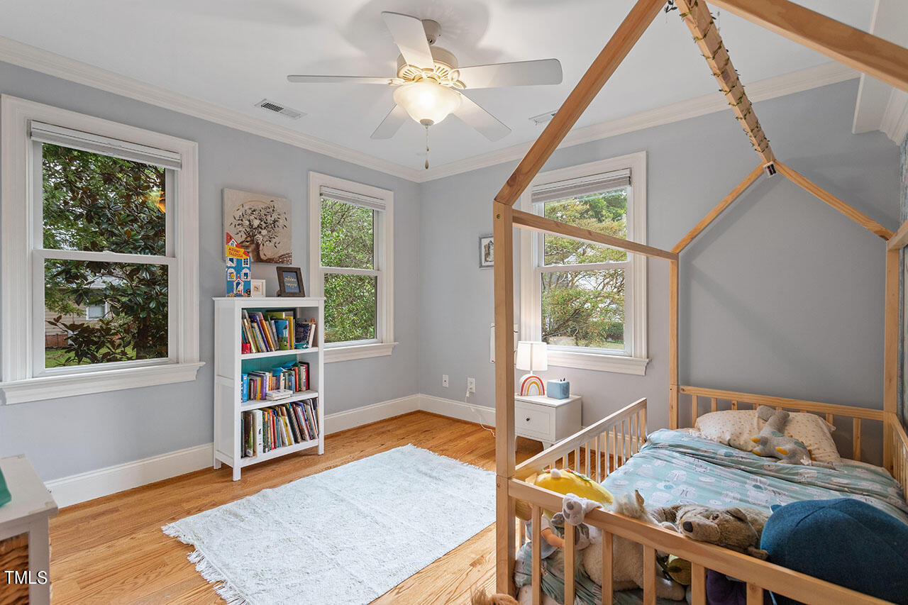 808 Elm Street Raleigh, NC 27604 - Photo 31 of 44 a bedroom with furniture window and wooden floor