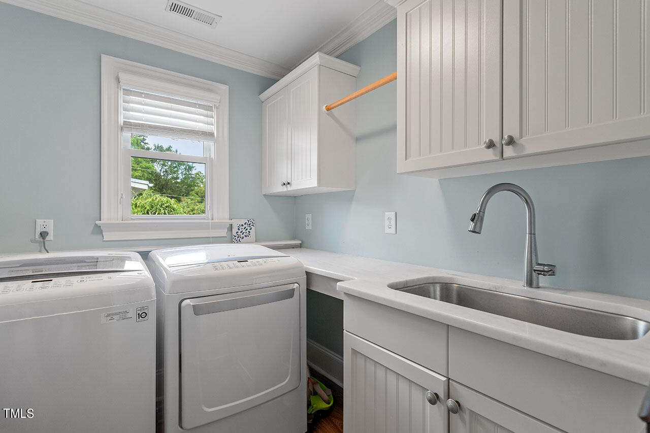 808 Elm Street Raleigh, NC 27604 - Photo 35 of 44 a view of a kitchen with sink and washer dryer