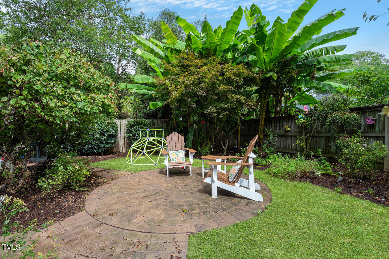 808 Elm Street Raleigh, NC 27604 - Photo 44 of 44 a view of backyard with wooden fence and large trees