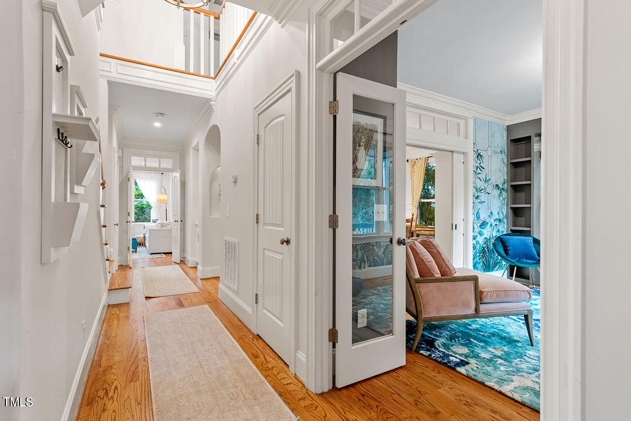 808 Elm Street Raleigh, NC 27604 - Photo 6 of 44 a view of a hallway with wooden floor and living room