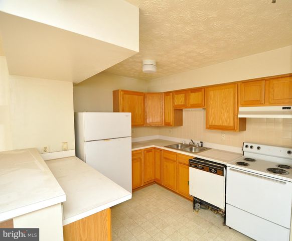 a kitchen that has a sink and a stove in it