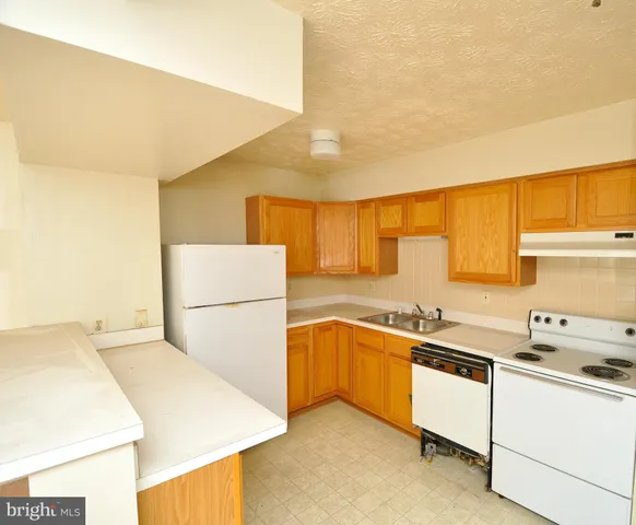a kitchen that has a sink and a stove in it