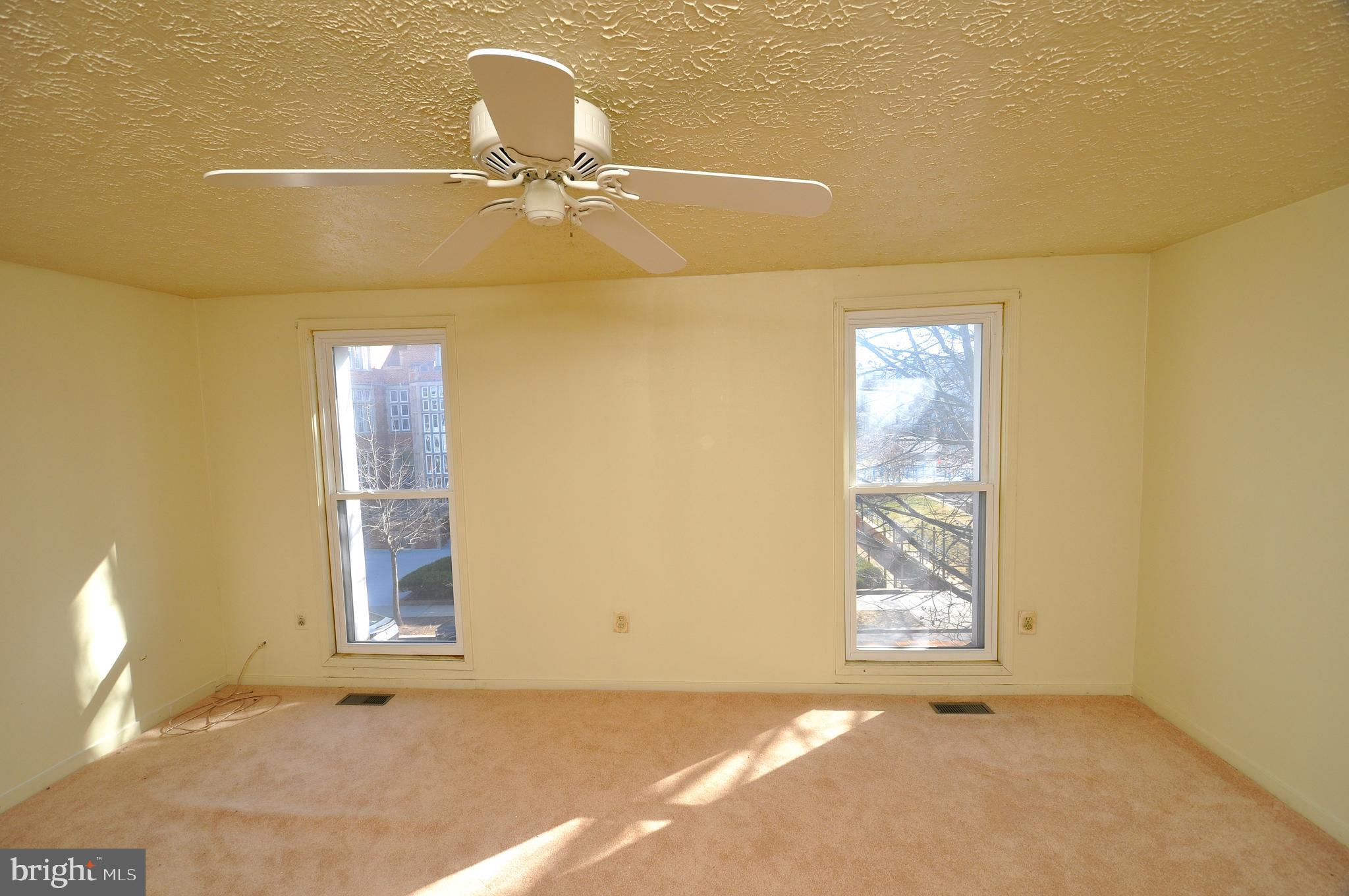 1121 Harvard Street Northwest, Unit F Washington, DC 20009 - Photo 6 of 7 a view of an empty room with a window