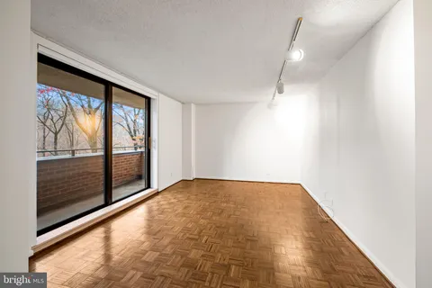 a view of empty room with large windows