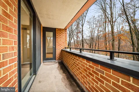 a view of balcony with mountain view and wooden floor