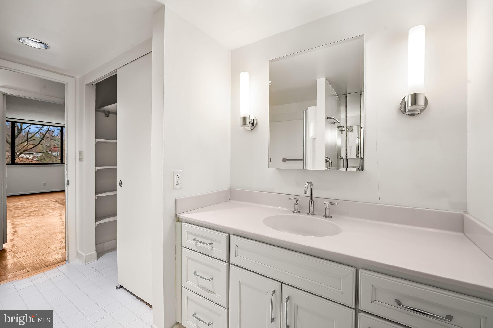 111 Hamlet Hill Road, Unit 412 Baltimore, MD 21210 - Photo 19 of 33 a bathroom with a sink and a mirror