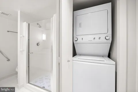 a white toilet sitting next to a bathroom sink
