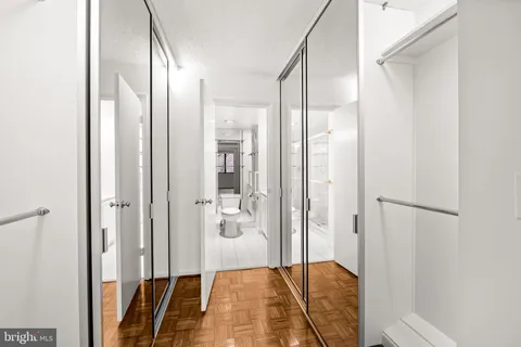 a bathroom with a glass door shower and a sink