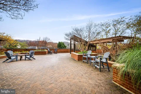 a view of a patio with table and chairs and couches