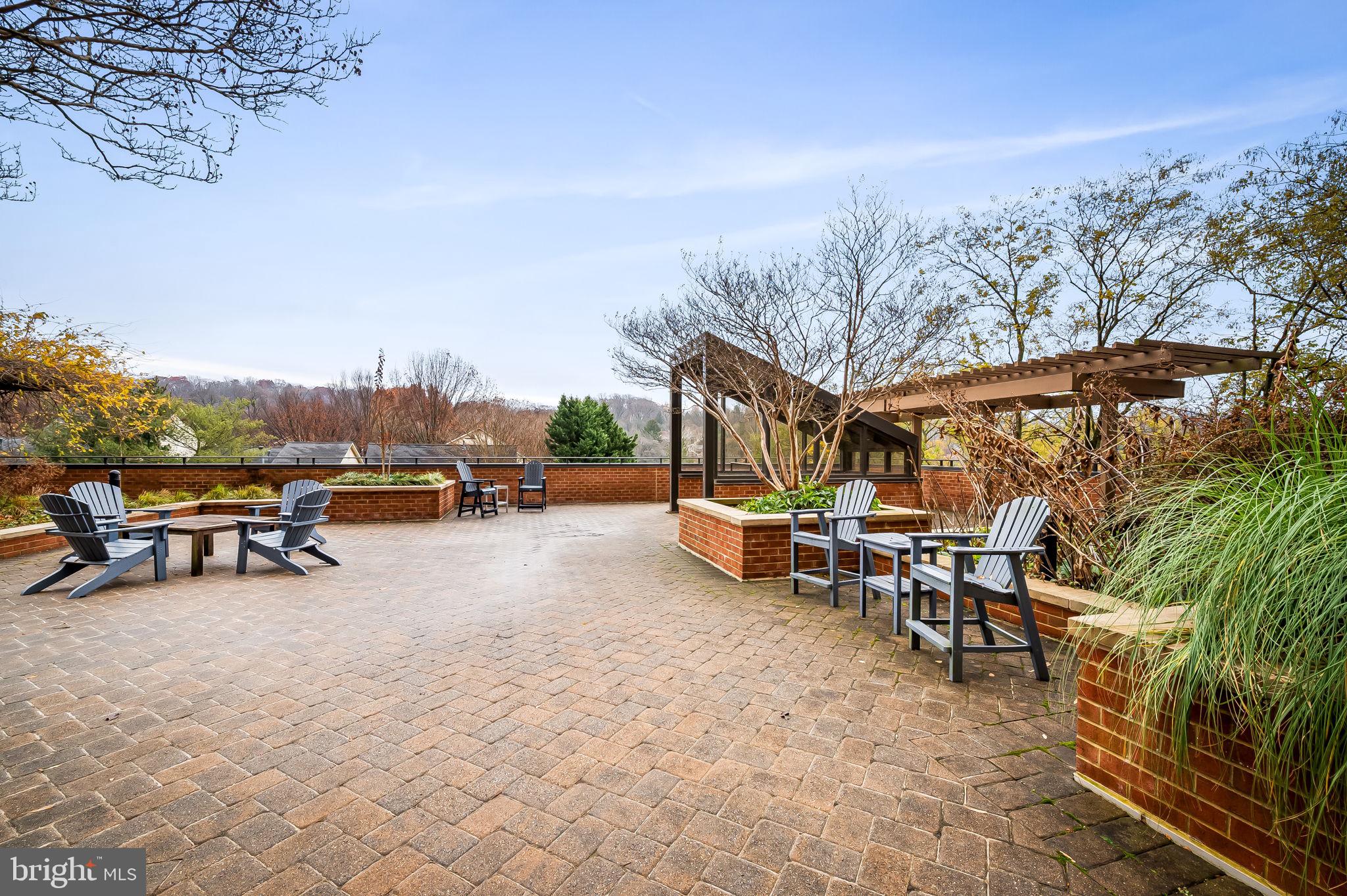 111 Hamlet Hill Road, Unit 412 Baltimore, MD 21210 - Photo 31 of 33 a view of a patio with table and chairs and couches