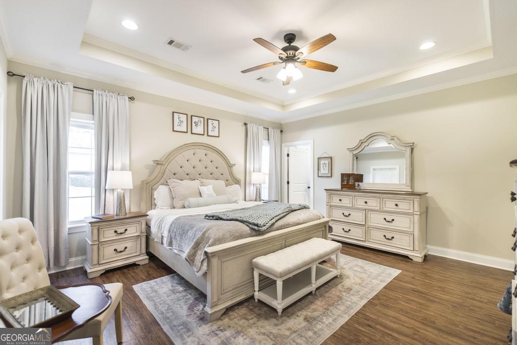 609 Live Oak Way Dublin, GA 31021 - Photo 20 of 37 a bedroom with a bed and wooden floor