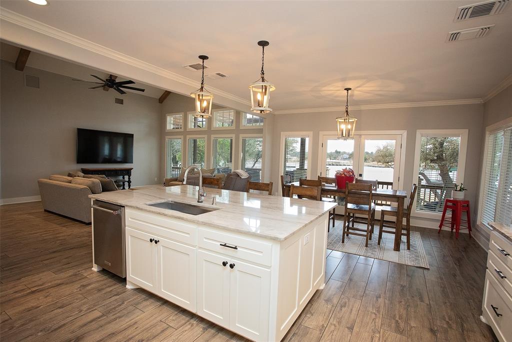 4827 Green Acres Road Graham, TX 76450 - Photo 19 of 32 a kitchen with a sink stove and wooden floor