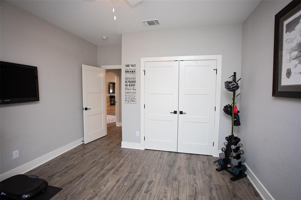 4827 Green Acres Road Graham, TX 76450 - Photo 23 of 32 a view of a room with wooden floor and windows