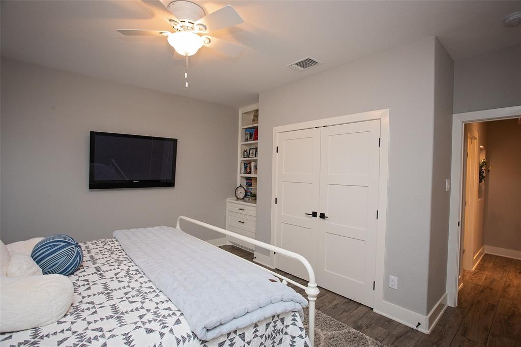4827 Green Acres Road Graham, TX 76450 - Photo 29 of 32 a bedroom with a bed and a flat screen tv