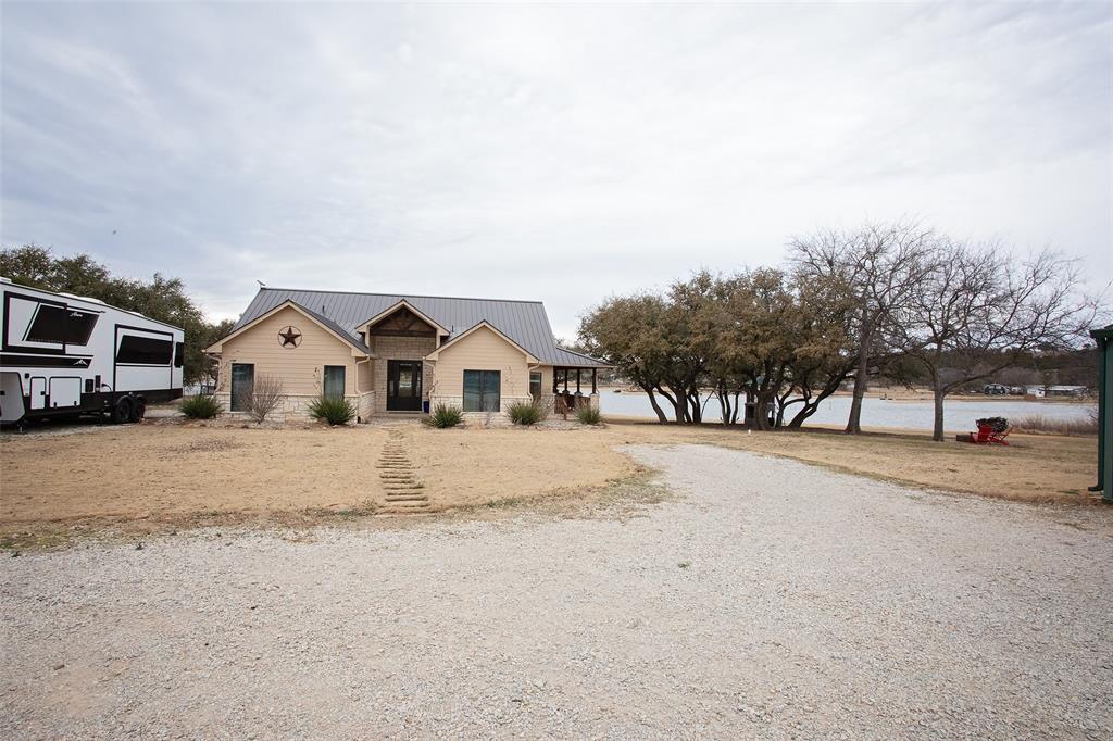4827 Green Acres Road Graham, TX 76450 - Photo 30 of 32 a view of a white house with a snow on the road
