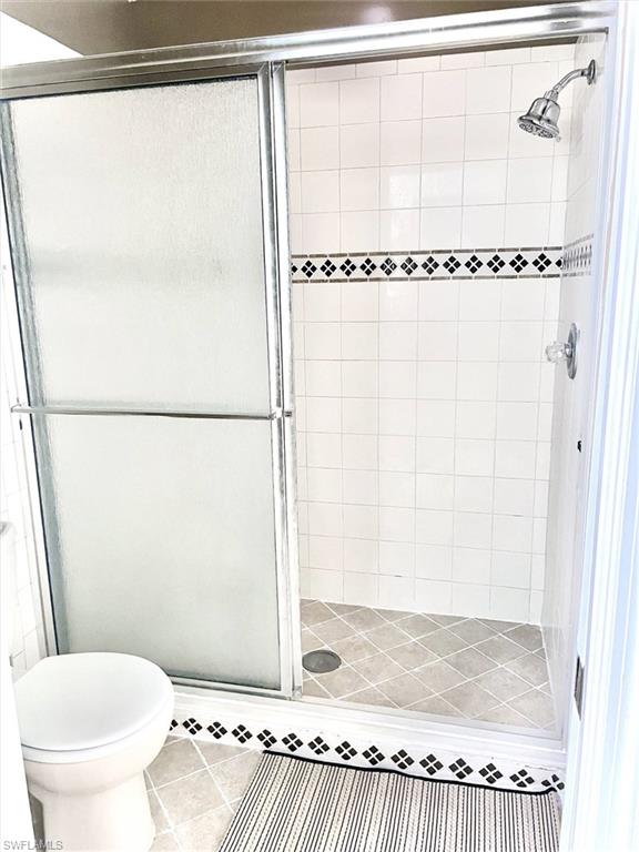 3634 Stone Way Estero, FL 33928 - Photo 11 of 27 a bathroom with a granite countertop shower and a toilet